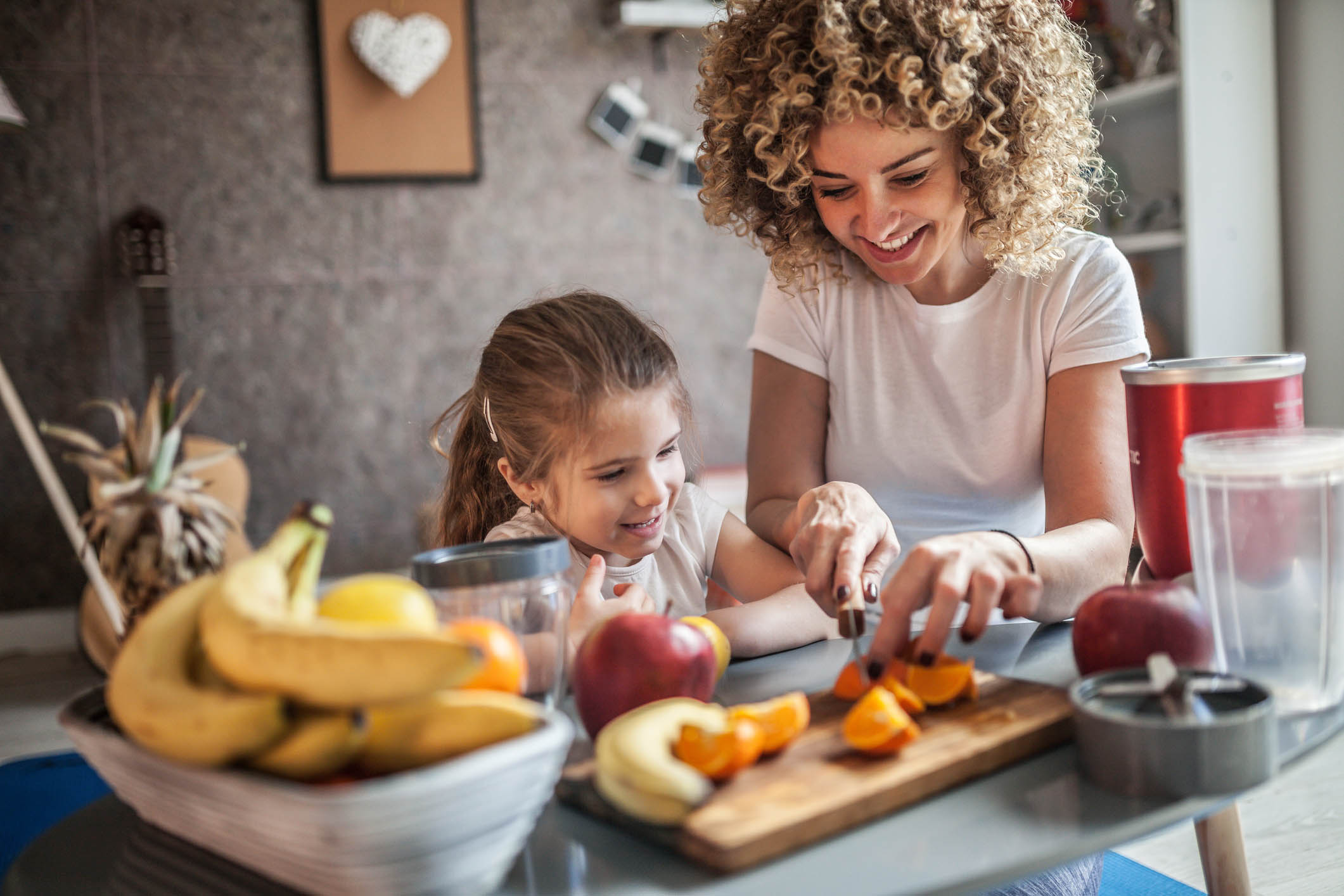 Mother and daughter making  smoothie