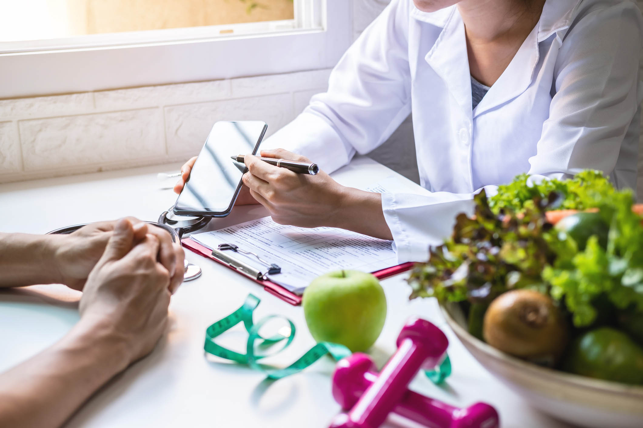 Nutritionist giving consultation to patient with healthy fruit and vegetable, Right nutrition and diet concept