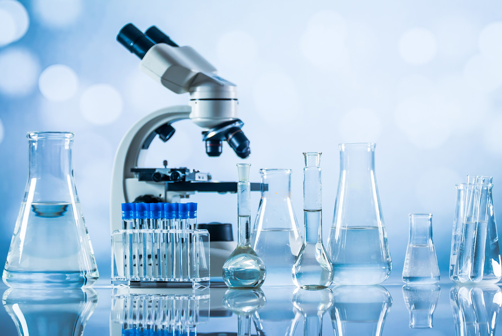 Smiling senior scientist with her colleagues in laboratory