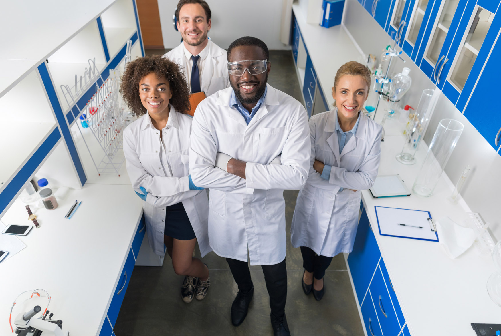 Smiling senior scientist with her colleagues in laboratory