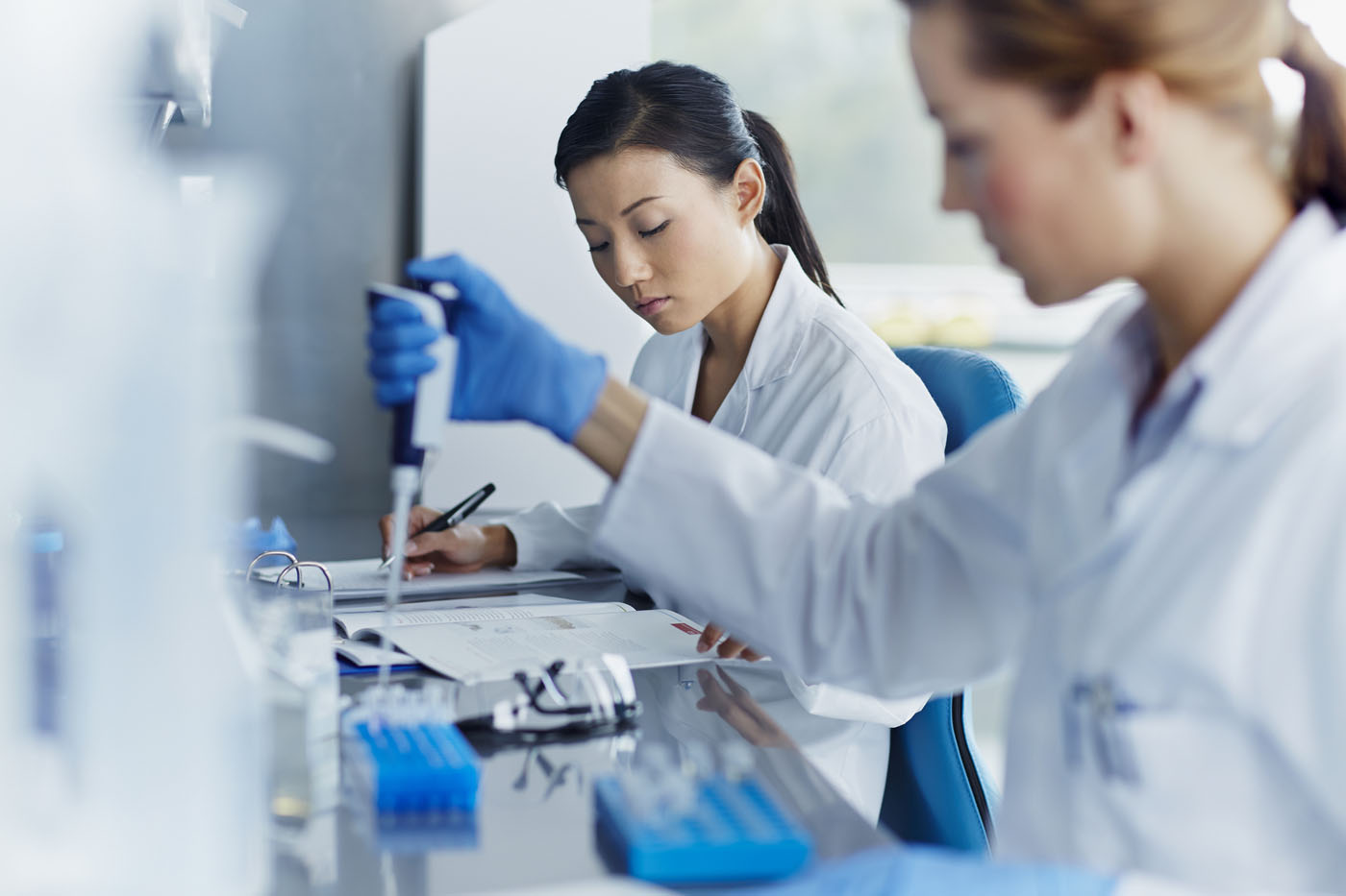 Female scientists working in modern biotechnology laboratory